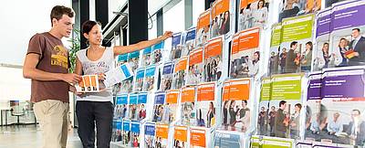 Man and woman picking out brochures