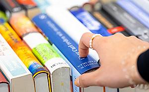 Hand über Bücherrücken