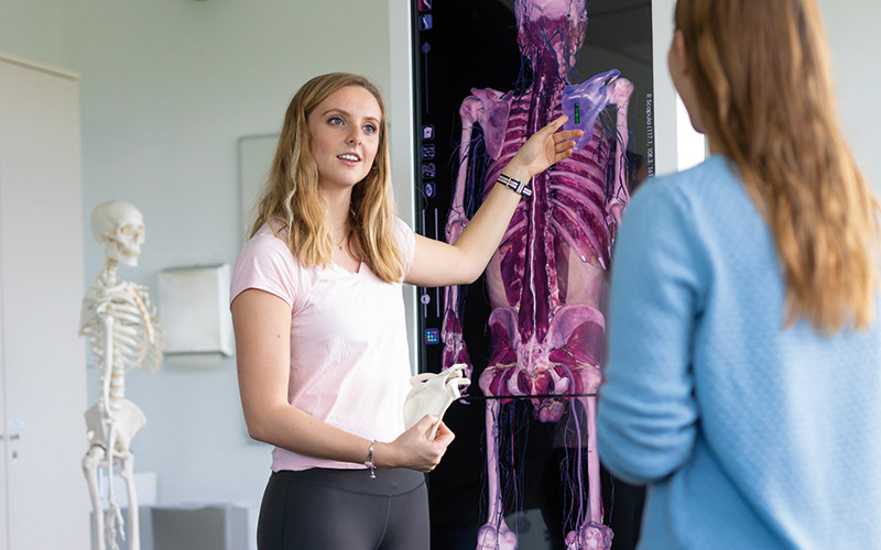 Woman pointing at a skeleton 