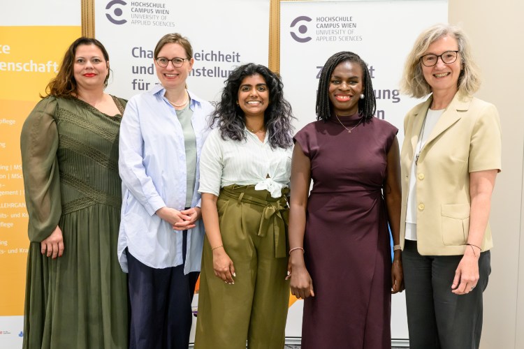 Fünf Frauen vor einem Rollup der HCW