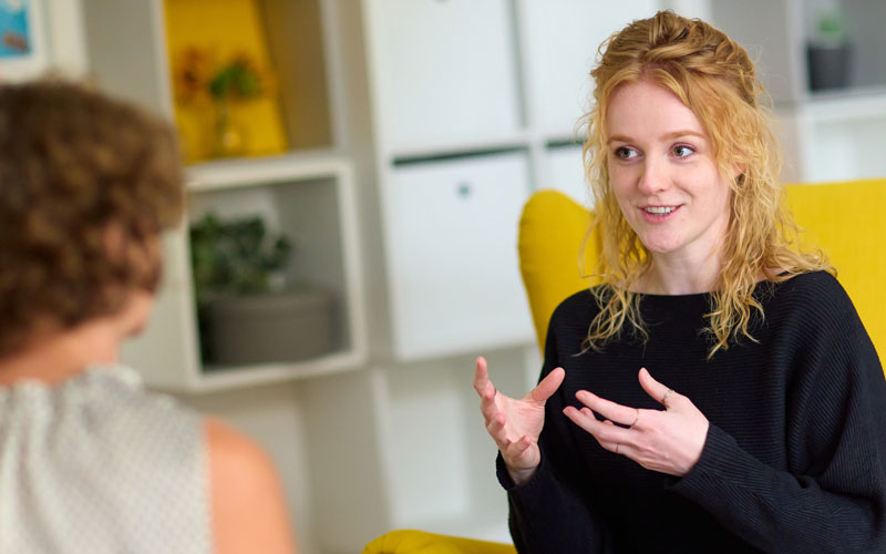 Social Work at university - Sarah Wolf in conversation with another person