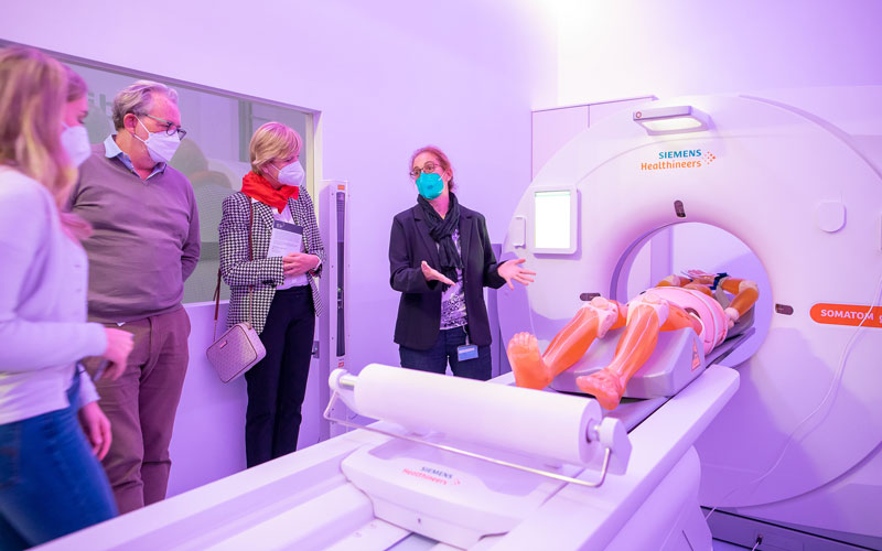 Lehrende steht vor CT und erklärt Funktionsweise.