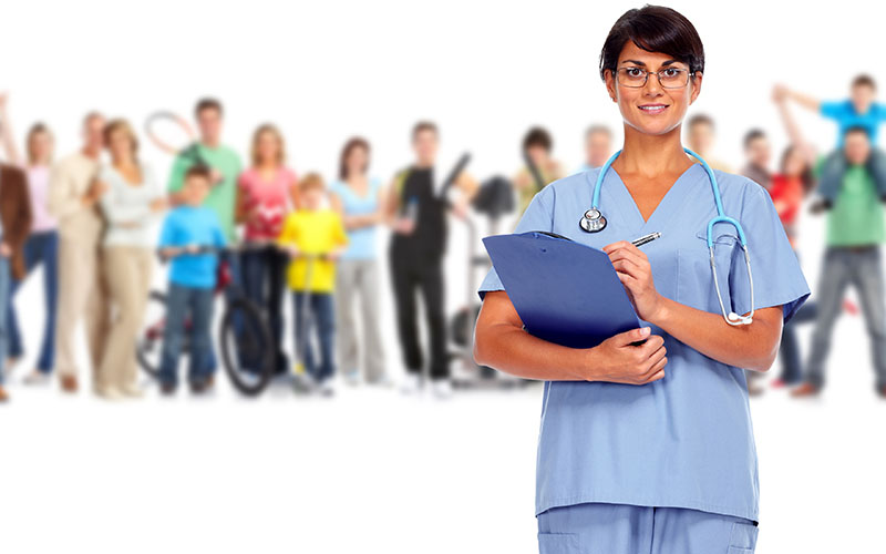 Nurse in front, group of people blurred in the backround