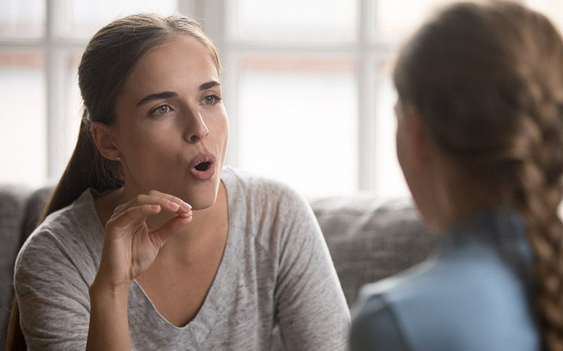 speech therapist demonstrates exercise