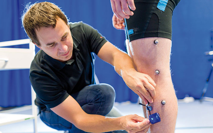 © HCW/Schedl Physiotherapist working on a persons knee